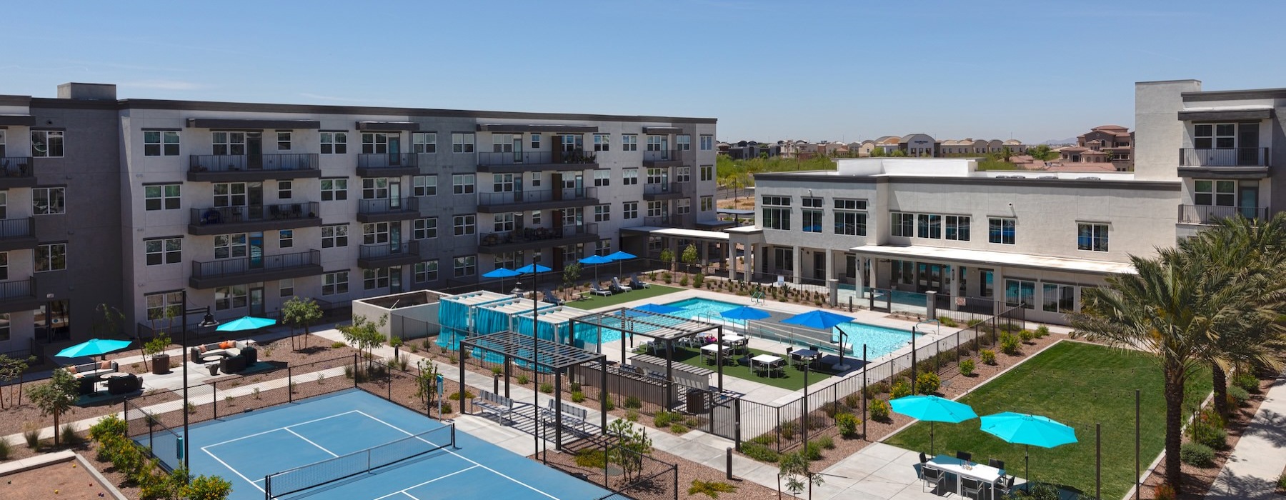 a swimming pool and a pickleball court in a courtyard
