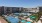 a swimming pool and a pickleball court in a courtyard
