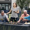 a group of people laughing around a fire