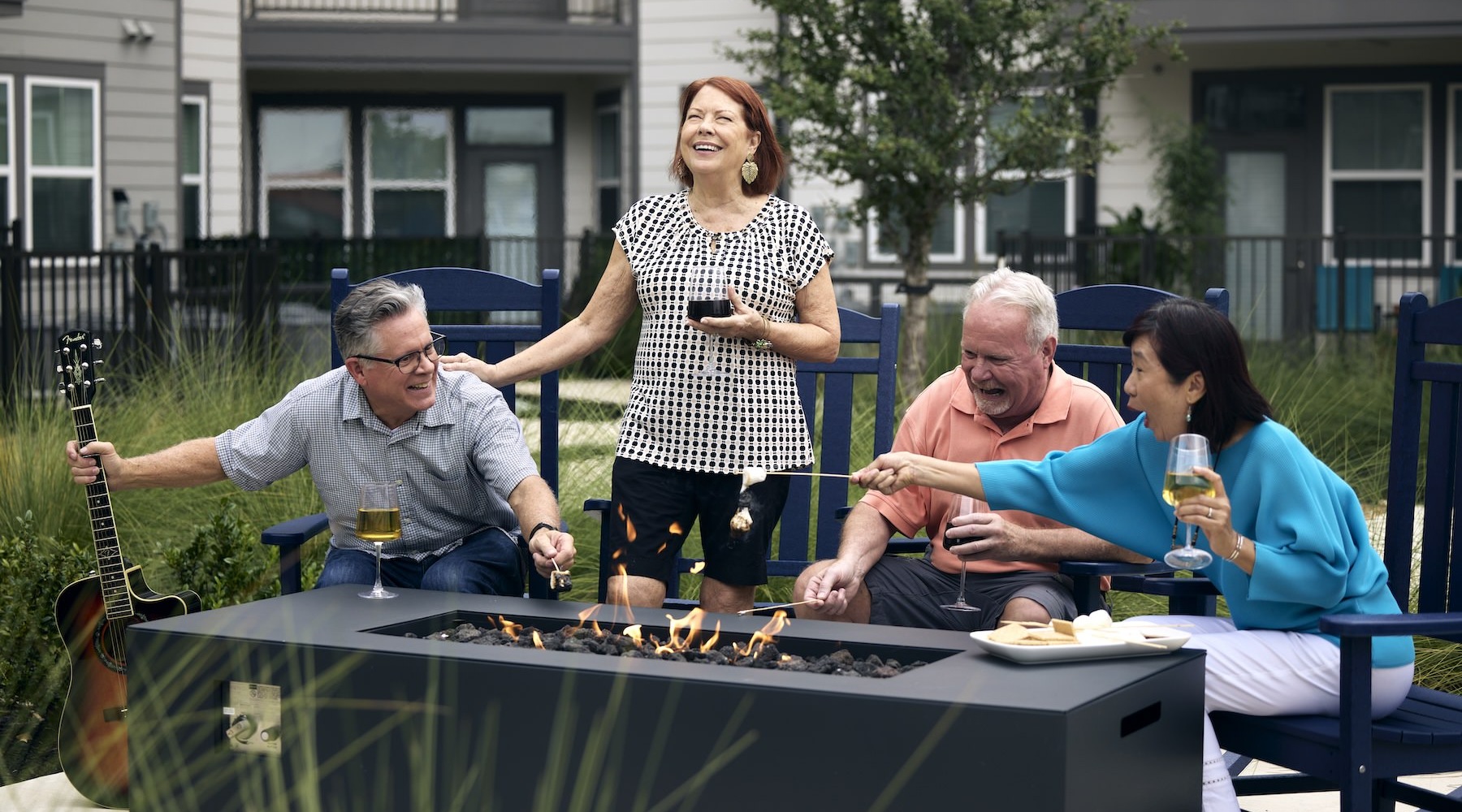 Love where you live a group of people laughing around a fire