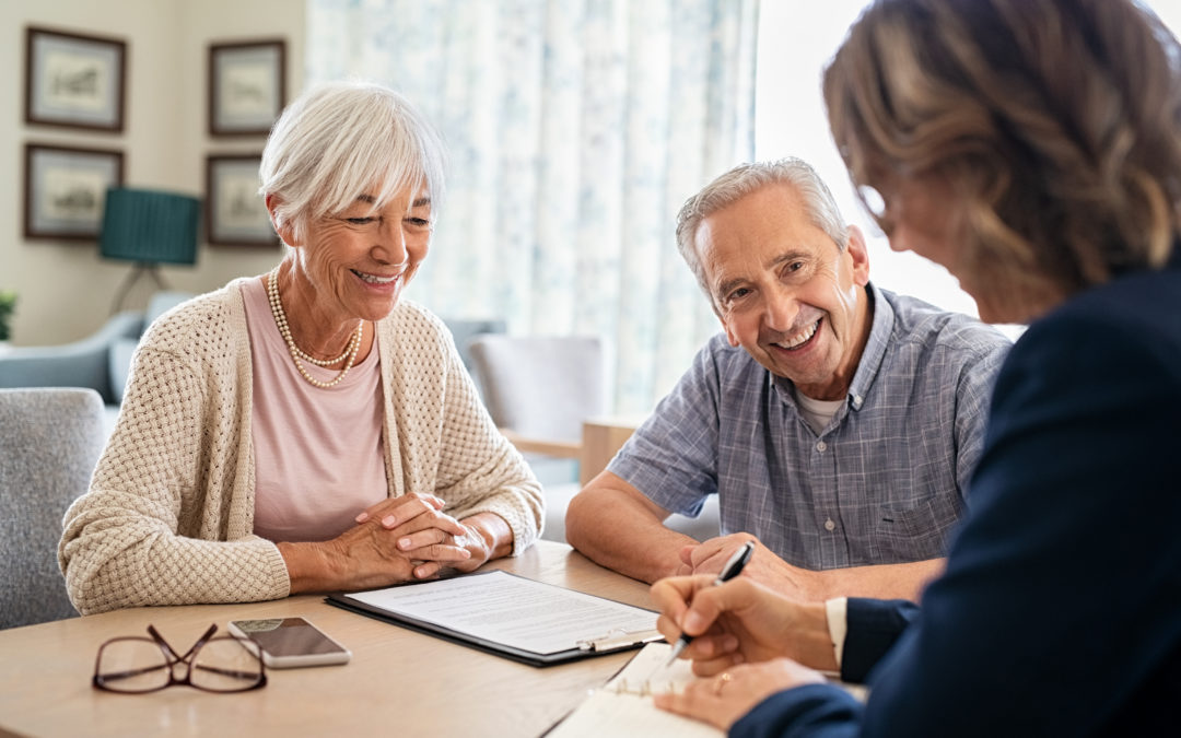 Senior couple consulting with apartment leasing agent